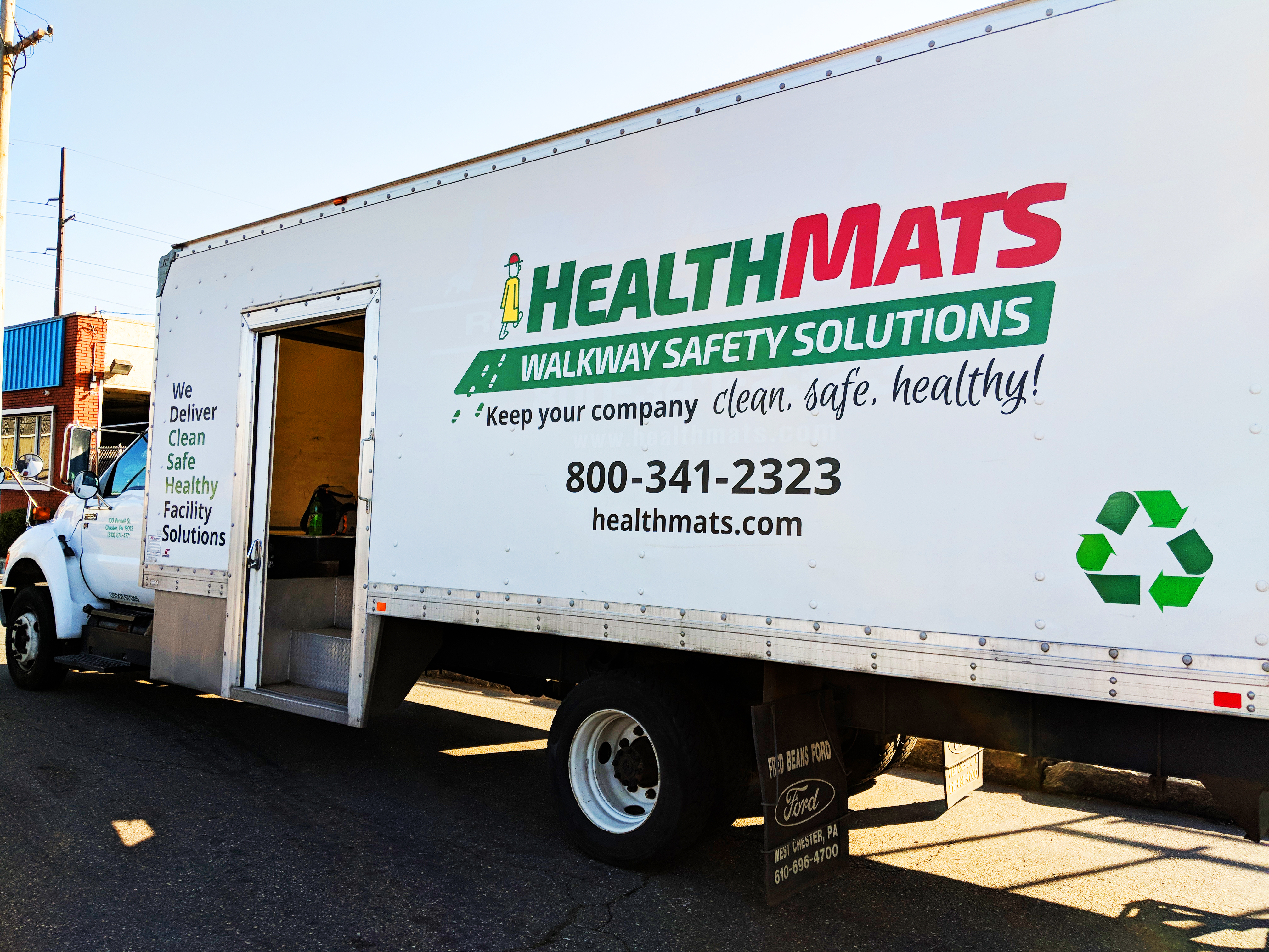 An image of the side of a branded Health Mats truck.