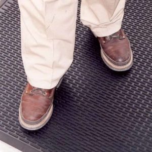 man with brown shoes on mat